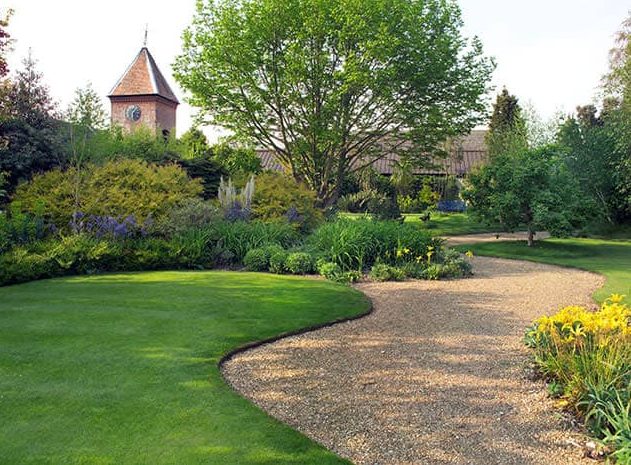 A small garden with curved lawn and gravel path