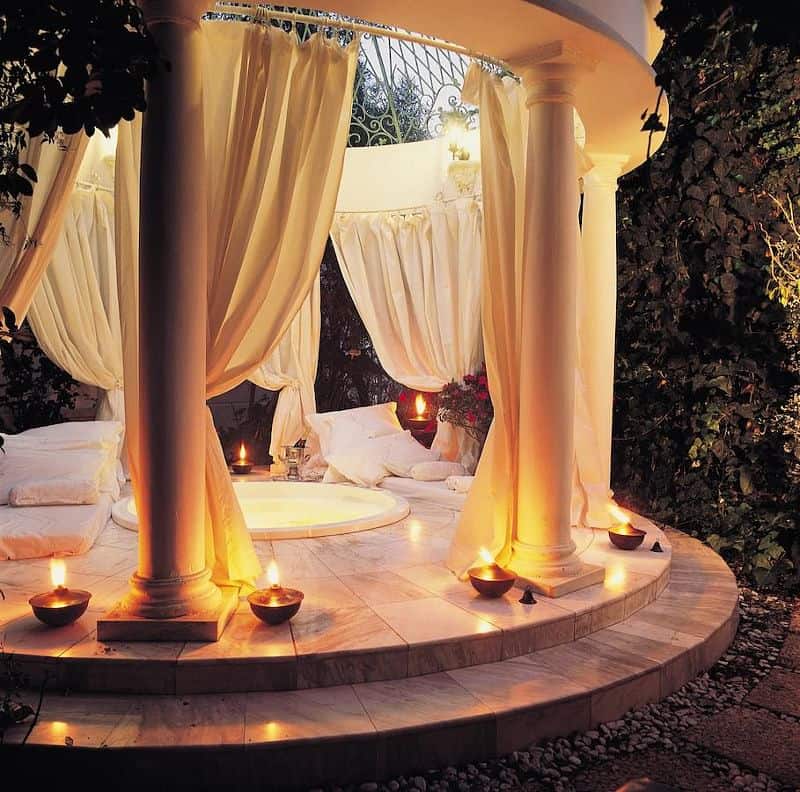 A Parthenon-inspired gazebo with drapes, and hot steam bath in the middle