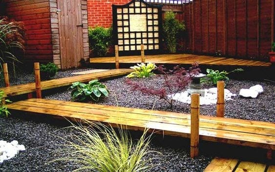 A wooden walkway over a pebble river