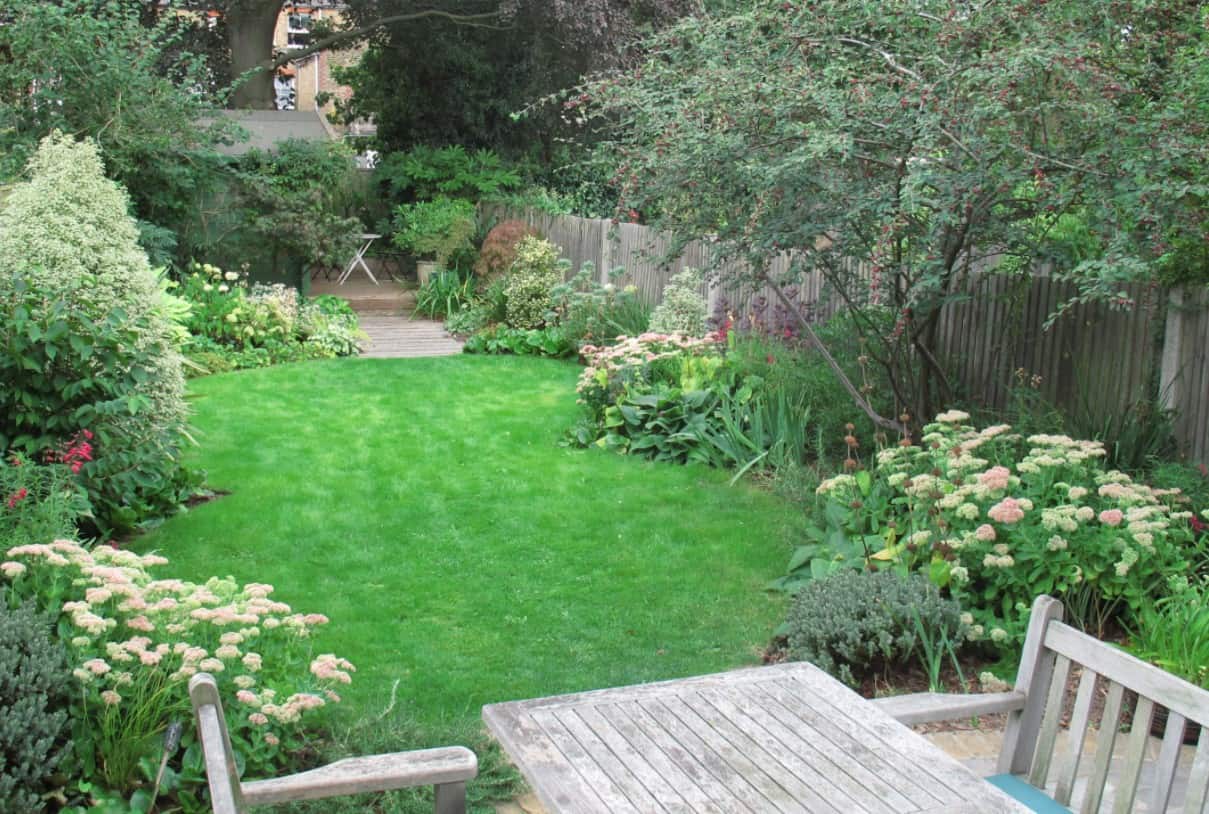 Oval lawns with a mini woodland at the rear