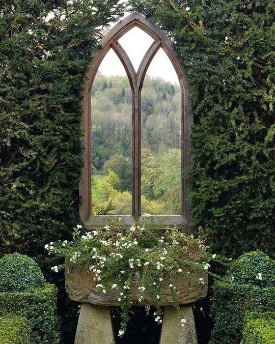 Mirror or window on hedge that are great for reflecting more sunlight into darker gardens