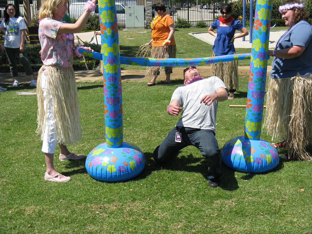 Family playing limbo game outdoors