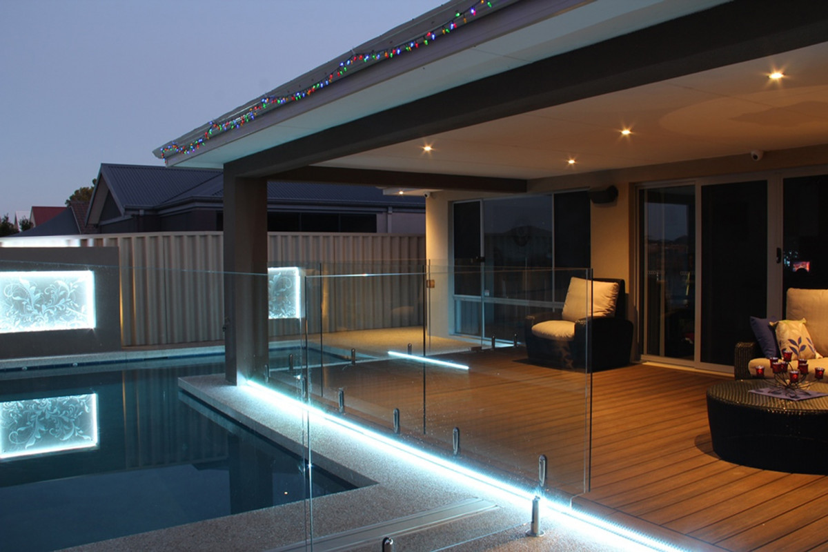 Decking around the pool with glass fencing